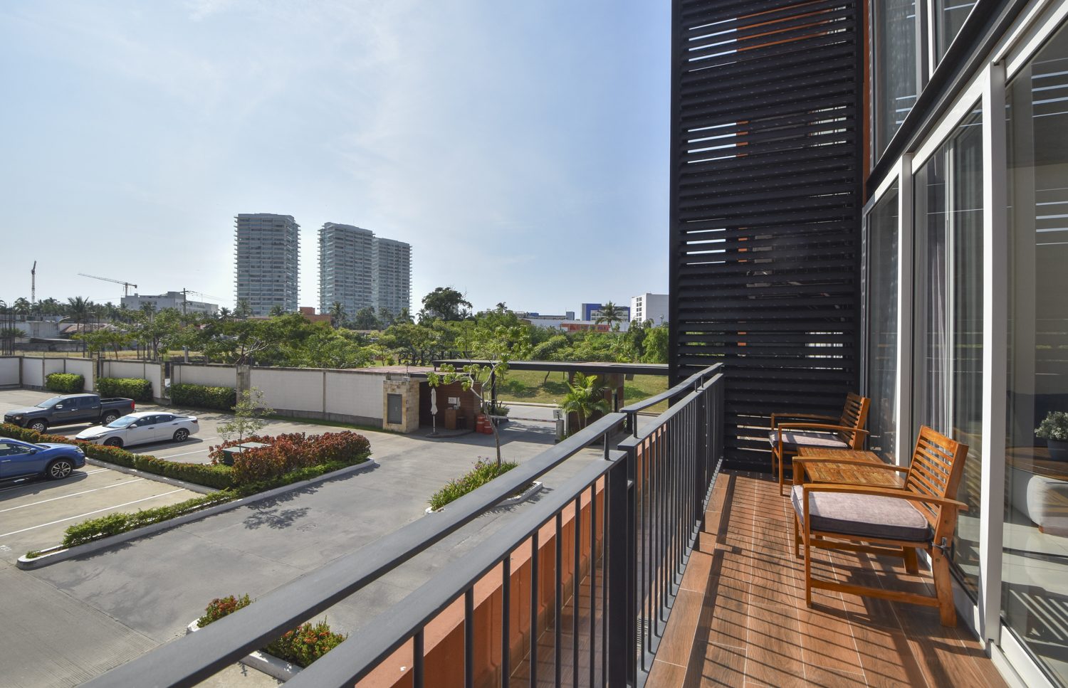 Balcony view toward Hotel Zone towers and greenery from Zoho Skies 108