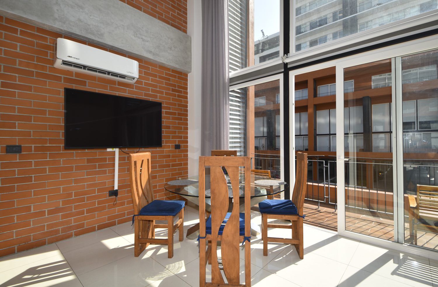 Double-height window wall and private balcony off the dining area, Zoho Skies 108, Hotel Zone Puerto Vallarta