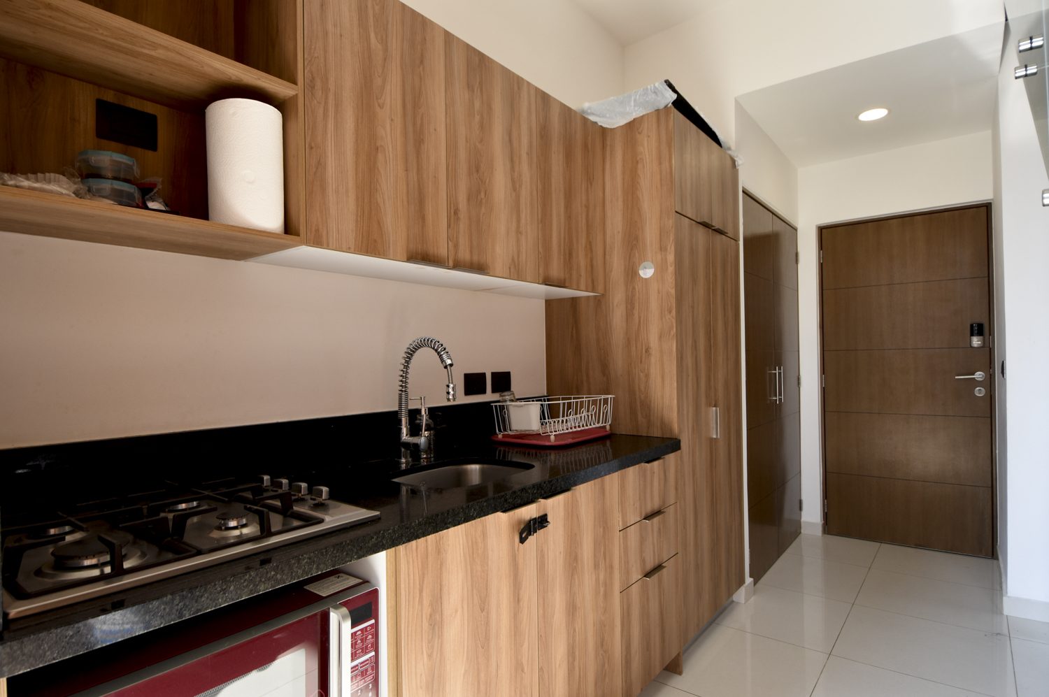 Kitchen with granite counters, gas cooktop and warm wood cabinetry