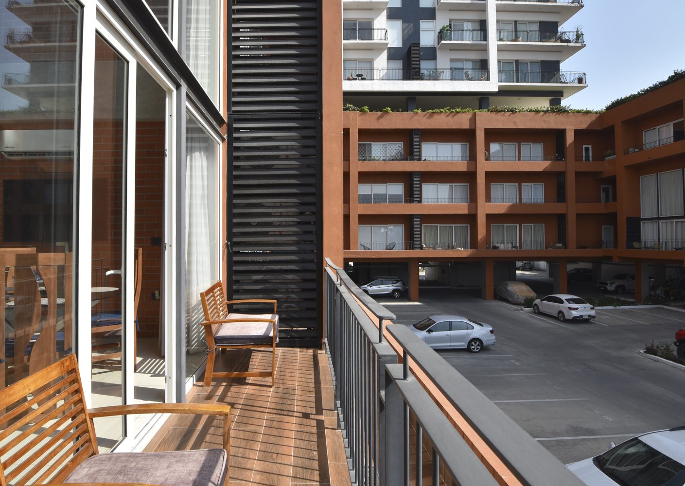 Private furnished balcony overlooking the Zoho Skies courtyard and parking