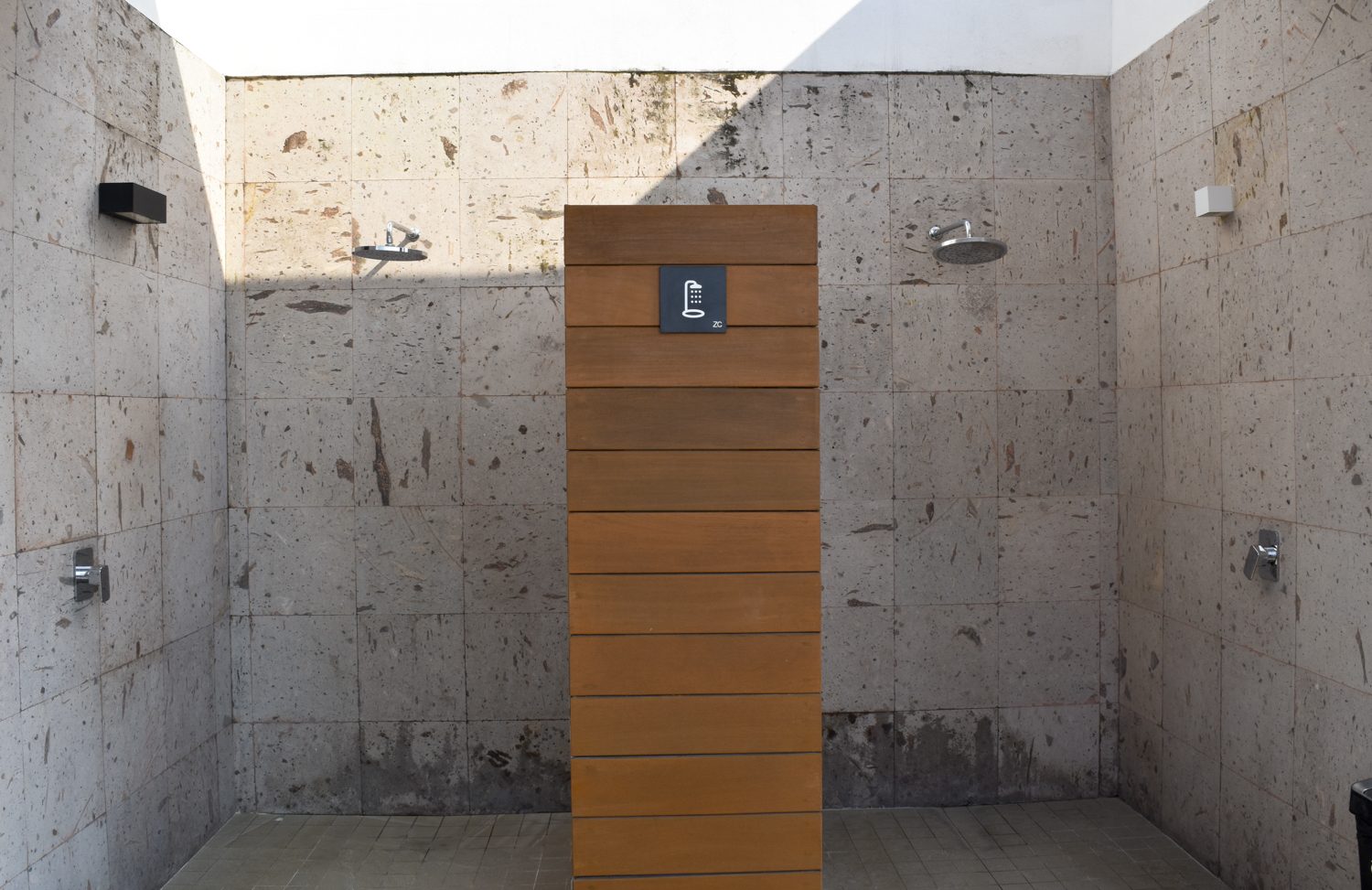 Stone-clad outdoor showers at the Zoho Skies amenity deck