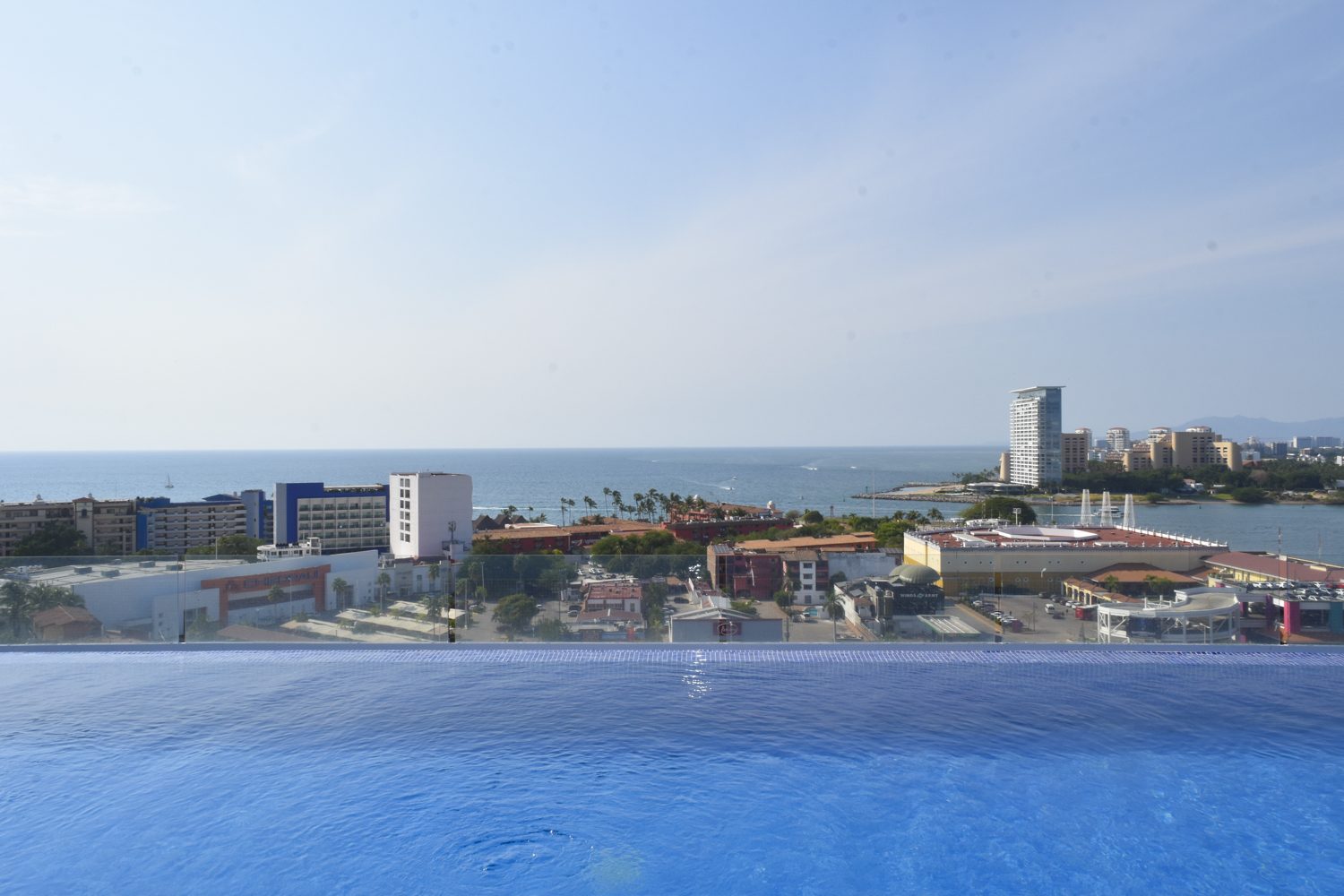 Rooftop infinity pool at Zoho Skies overlooking Banderas Bay, the marina and the Hotel Zone
