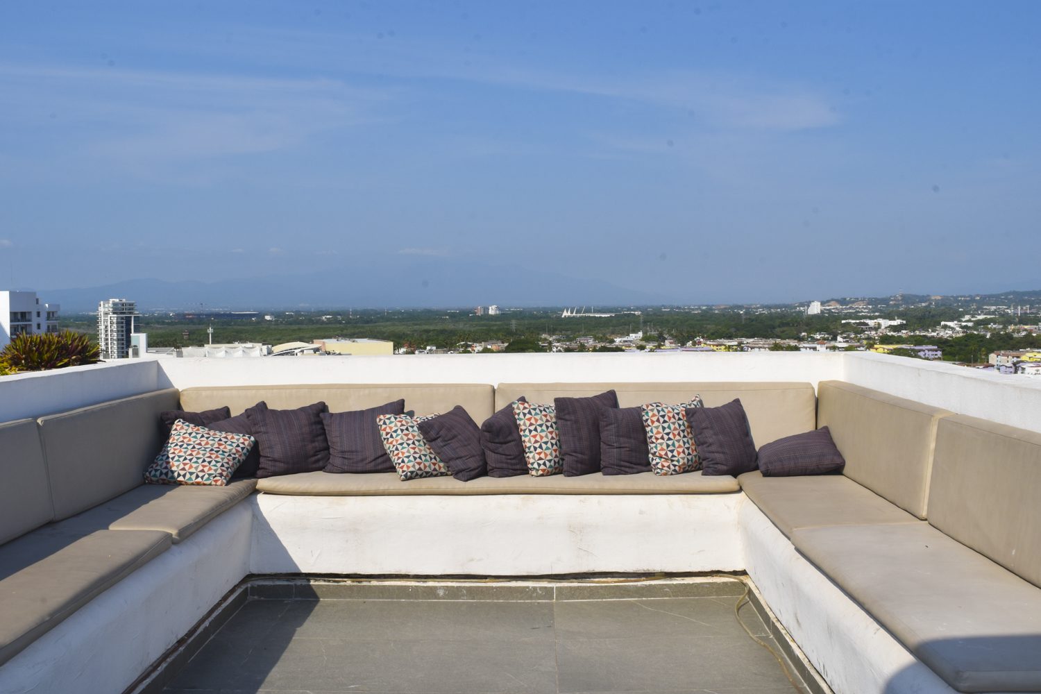 Rooftop lounge seating at Zoho Skies with Sierra Madre mountain views